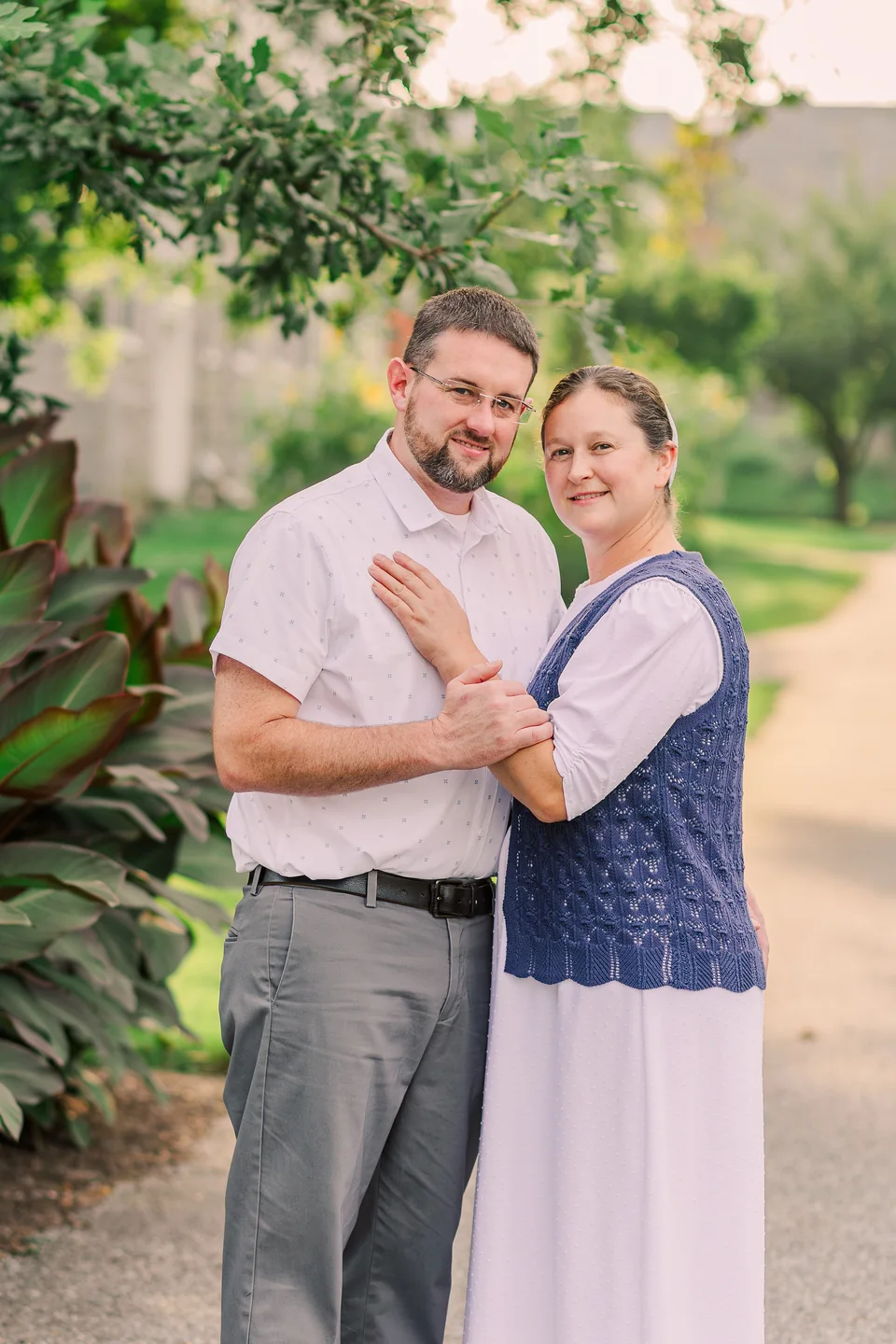 Kirby and his wife standing together in a garden.